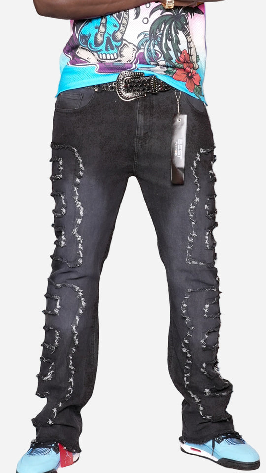 Person wearing distressed black jeans with a cityscape in the background