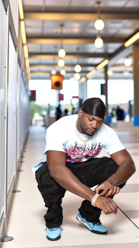 Man adjusting his shoe in a modern indoor setting