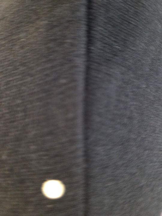 Close-up of a dark gray fabric texture with a button.