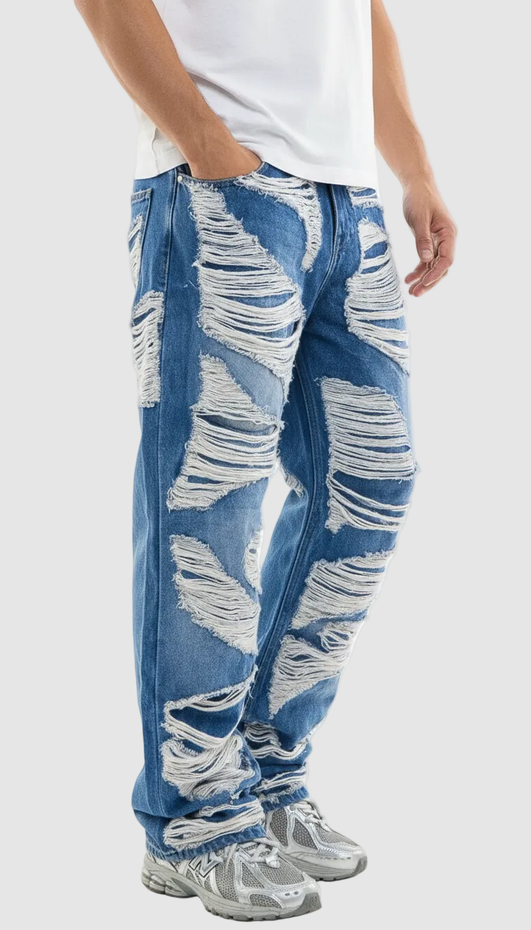 Person wearing distressed blue jeans on a white background