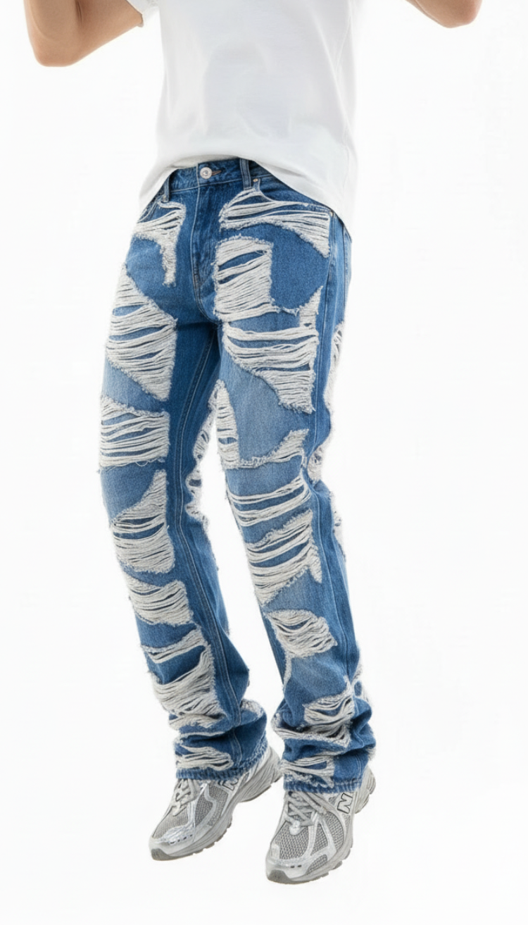 Blue distressed jeans worn by a person on a white background