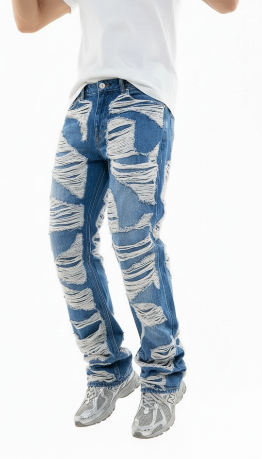 Blue distressed jeans worn by a person on a white background