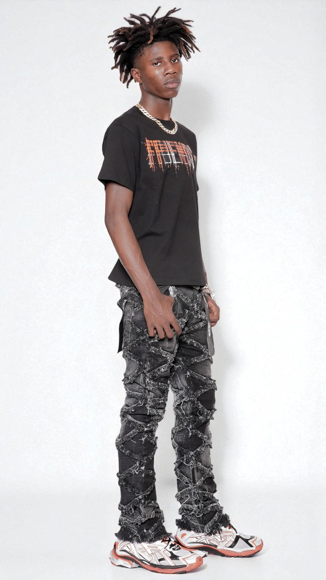 Person wearing a black t-shirt with text and camouflage pants on a white background