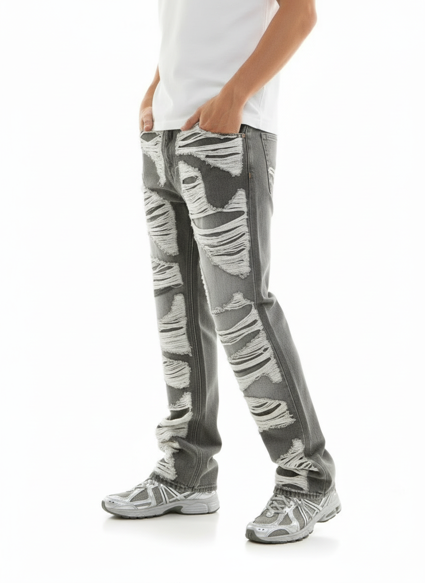 Person wearing gray distressed jeans on a white background