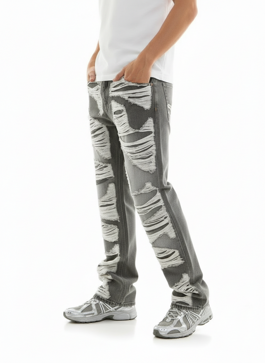 Person wearing gray distressed jeans on a white background