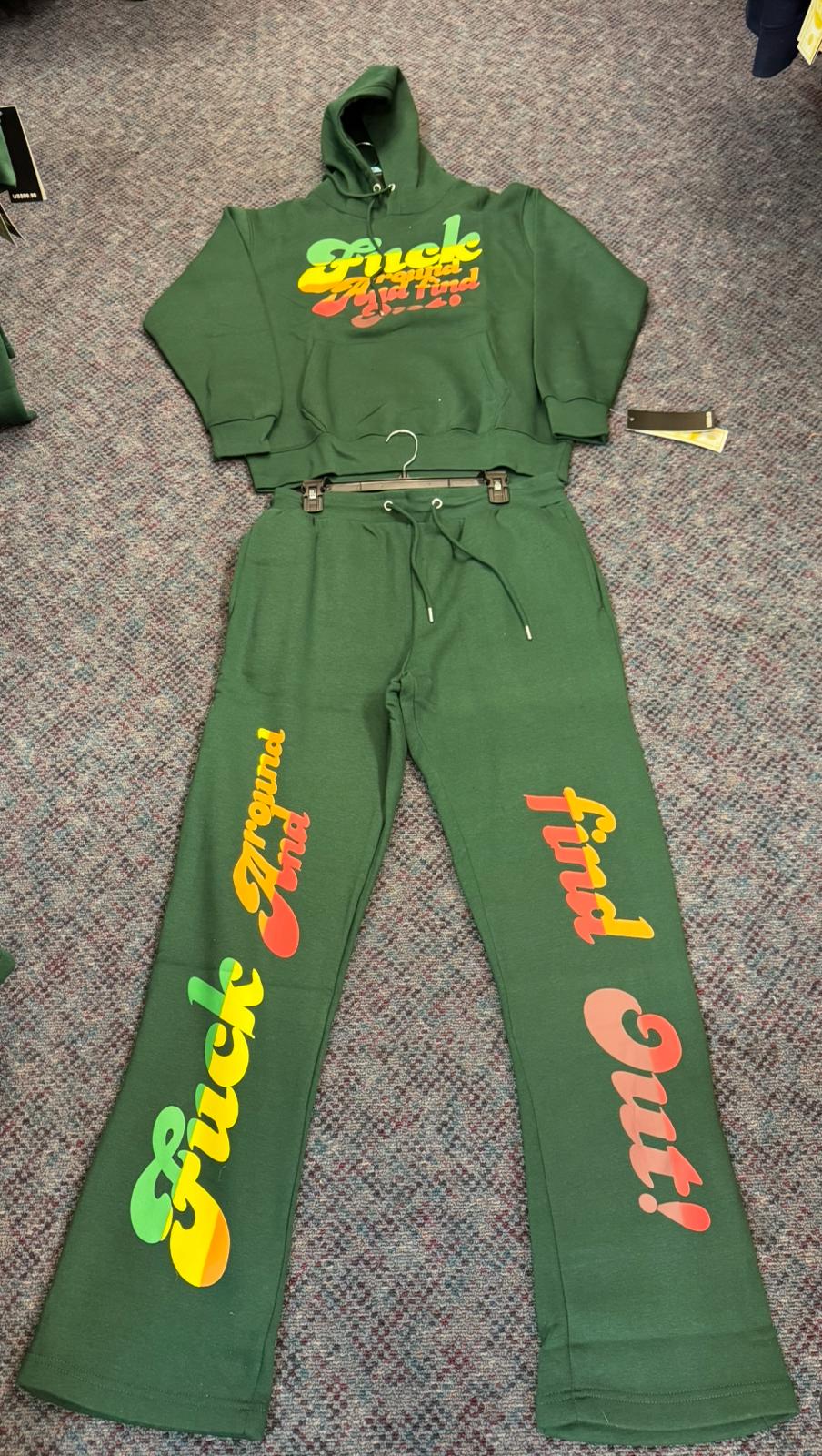 Green tracksuit with colorful text on a textured surface