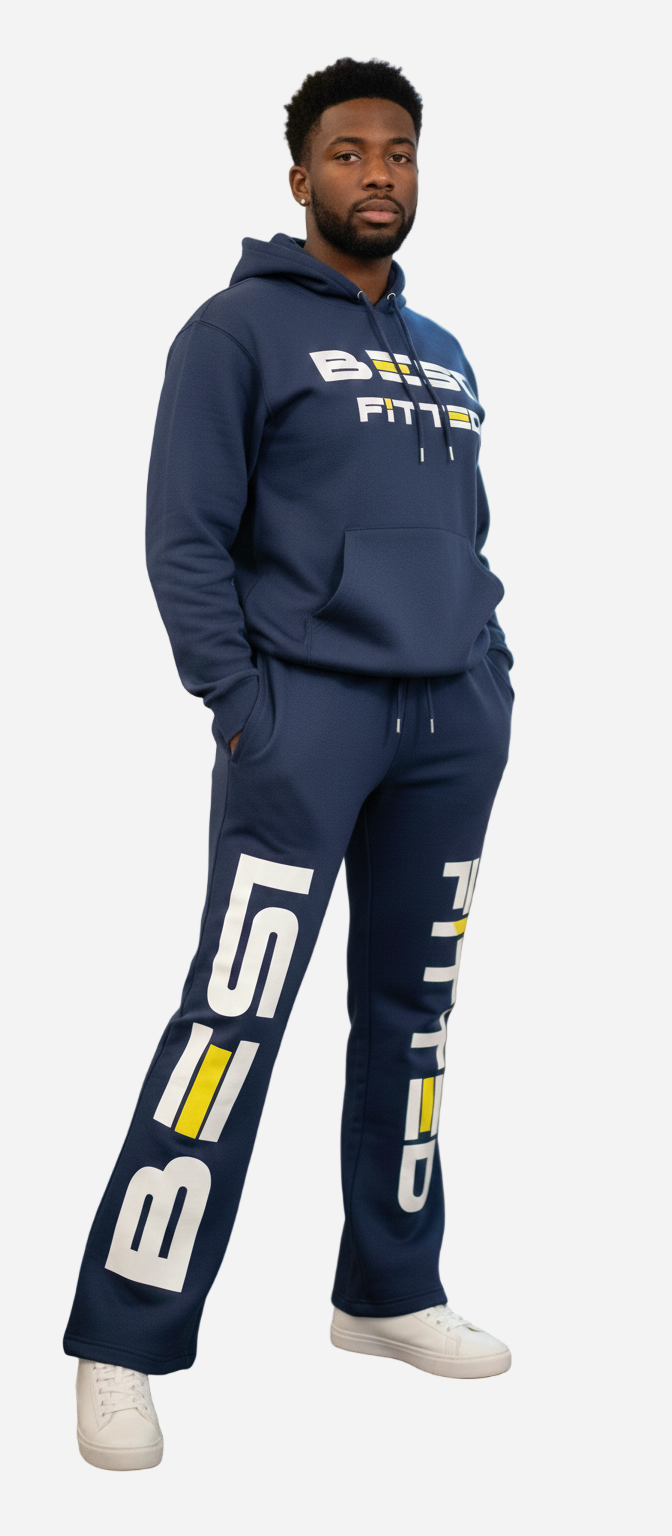 Person wearing navy blue 'Busted Fitts' hoodie and pants in an indoor setting.