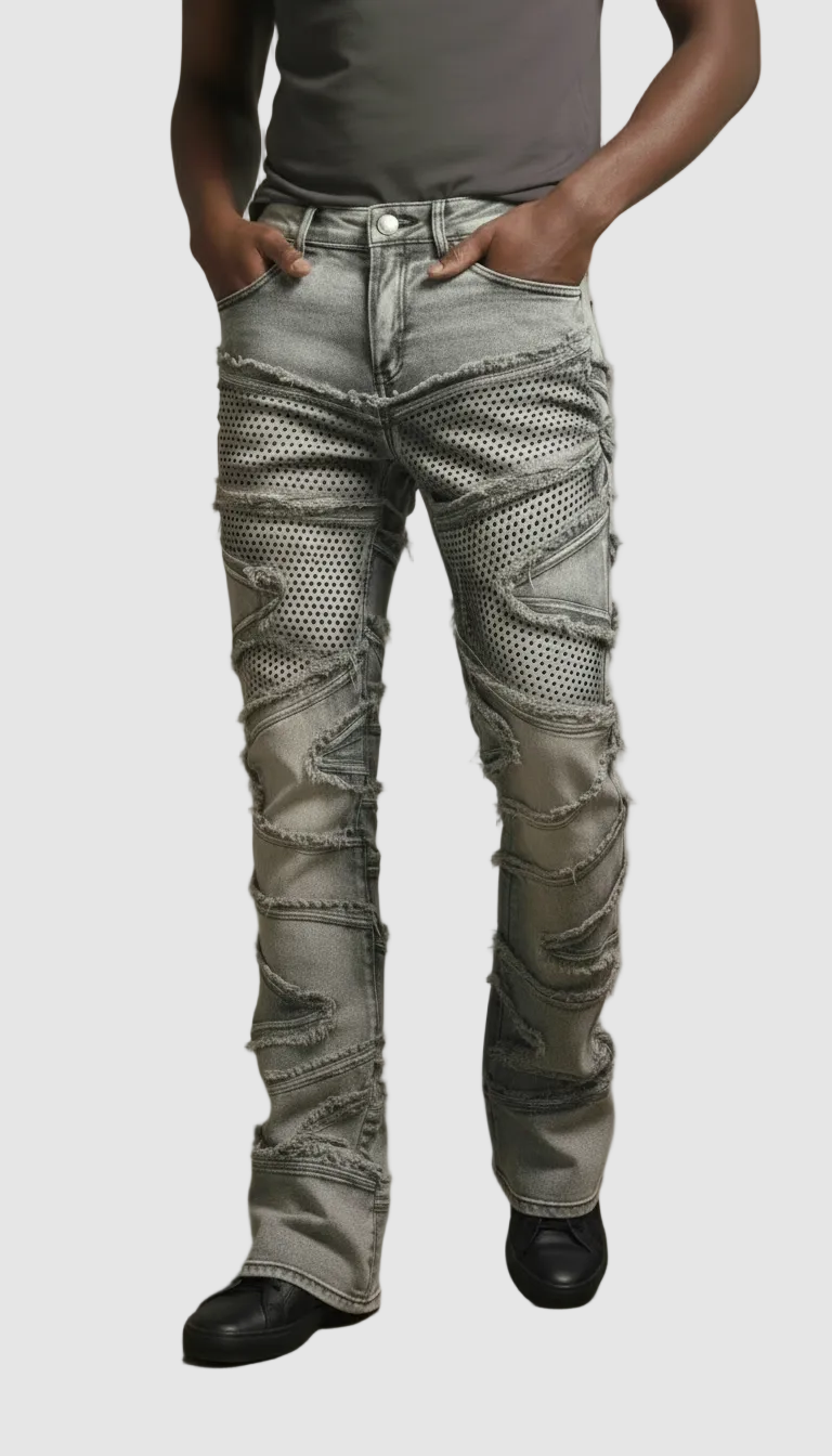 Person wearing distressed gray jeans with a plain background