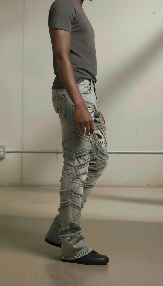 Person wearing gray cargo pants and a dark shirt against a plain background