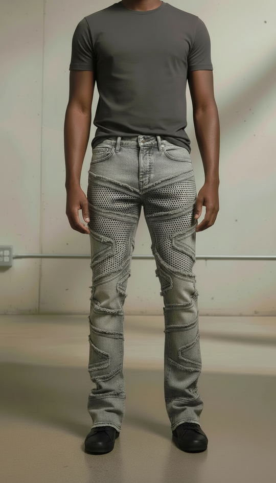 Person wearing a gray t-shirt and light gray jeans against a neutral background