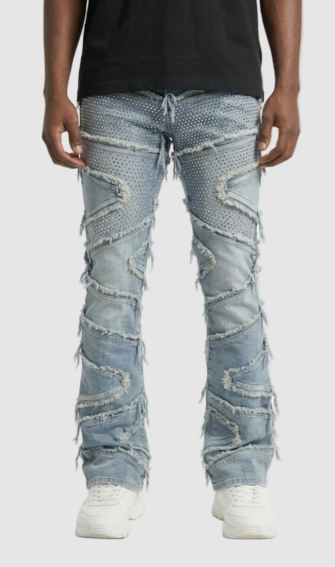 Person wearing light blue distressed jeans on a white background