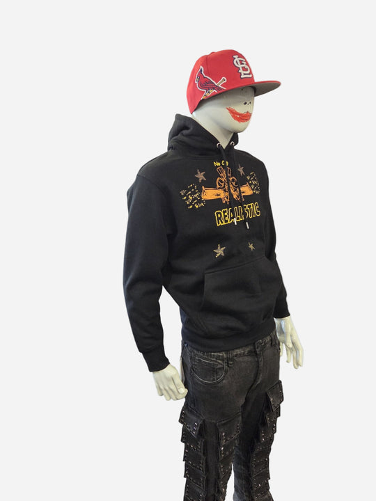 Mannequin wearing a black hoodie with text and graphics, paired with a red cap and dark pants on a white background.