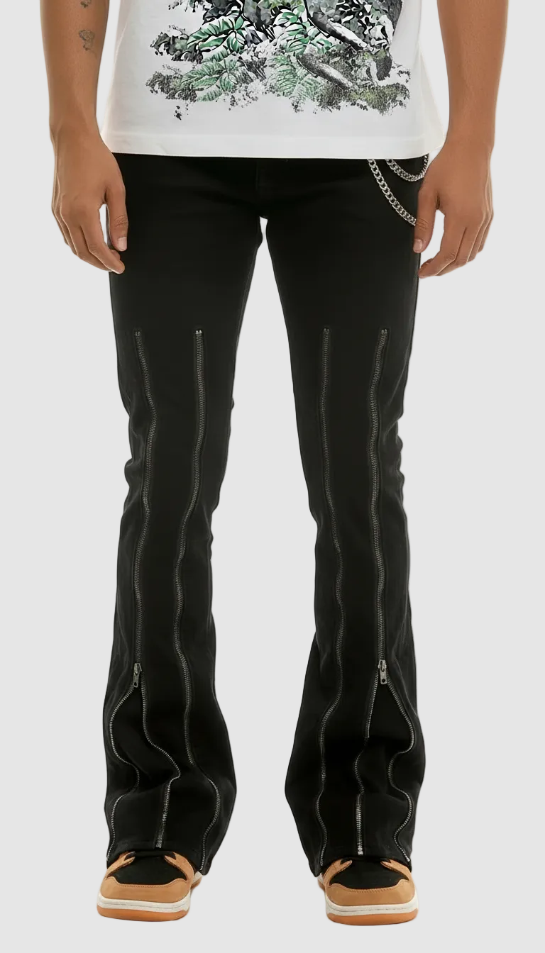Person wearing black pants with zippers on a white background