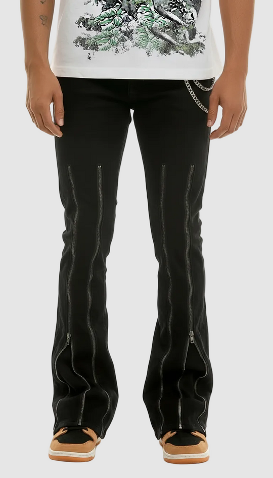 Person wearing black pants with zippers on a white background