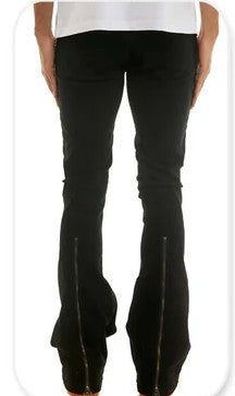 Black flared pants worn by a person on a white background