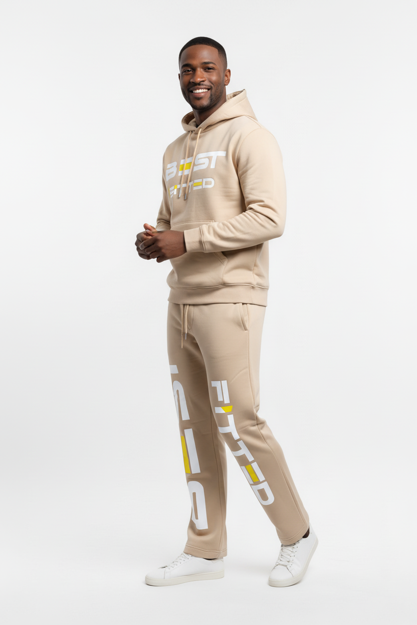 Man wearing a beige tracksuit with brand logos on a white background