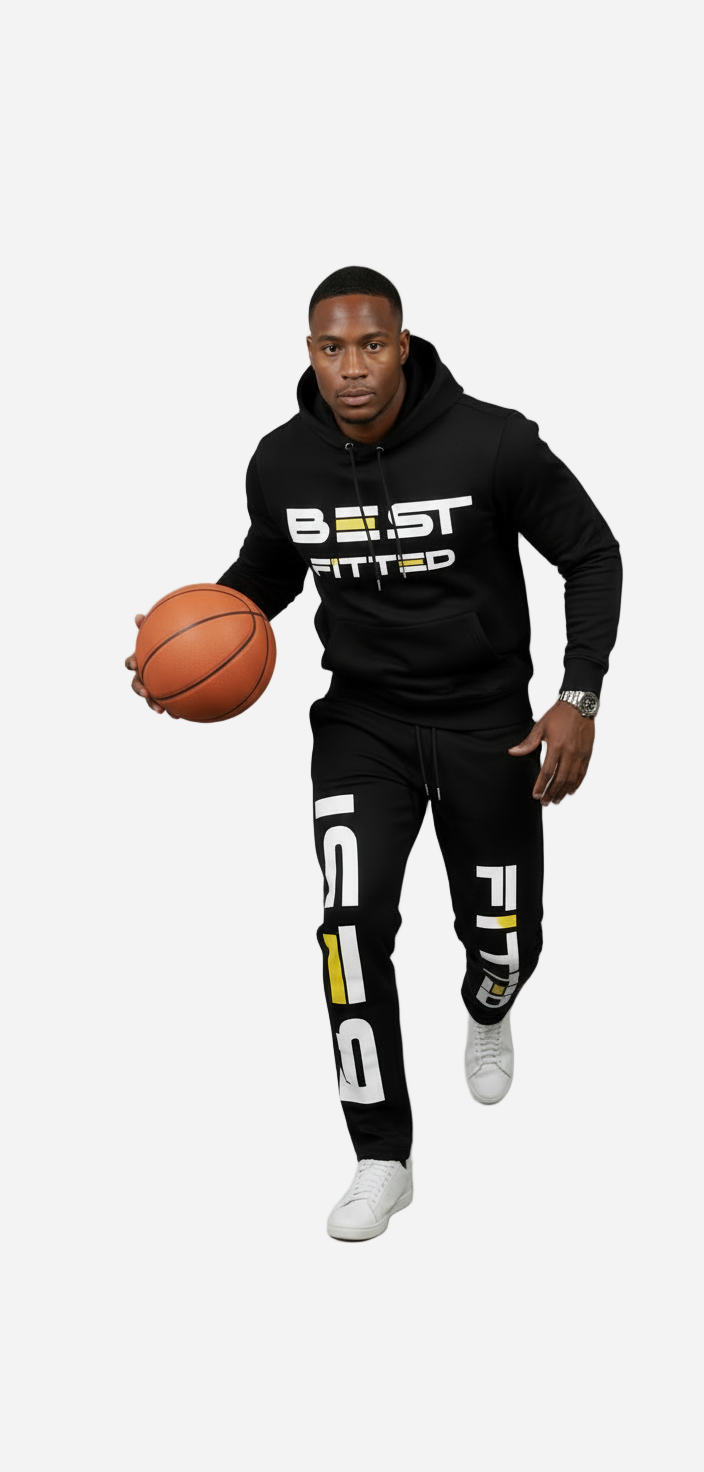 Person wearing a black 'BEAST FITTED' hoodie and pants holding a basketball on a gray background