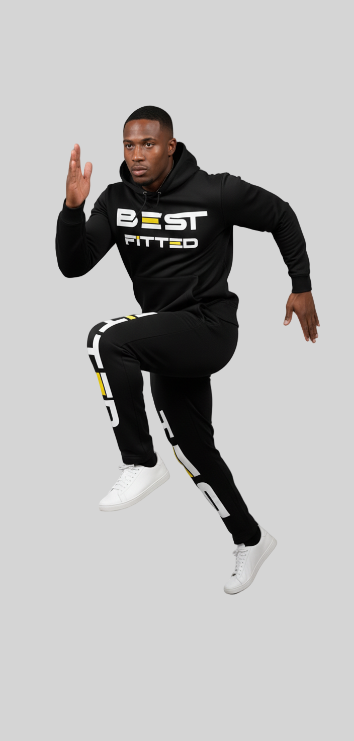 Man wearing a black hoodie and pants with 'BEST FITTED' text, posing against a gray background