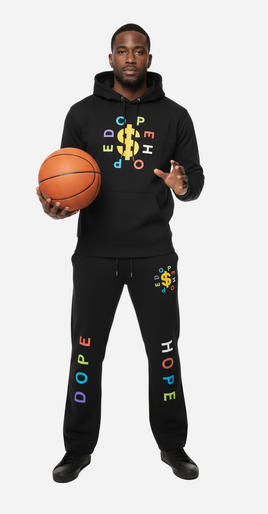 Person wearing a black hoodie and pants with colorful text, holding a basketball on a white background
