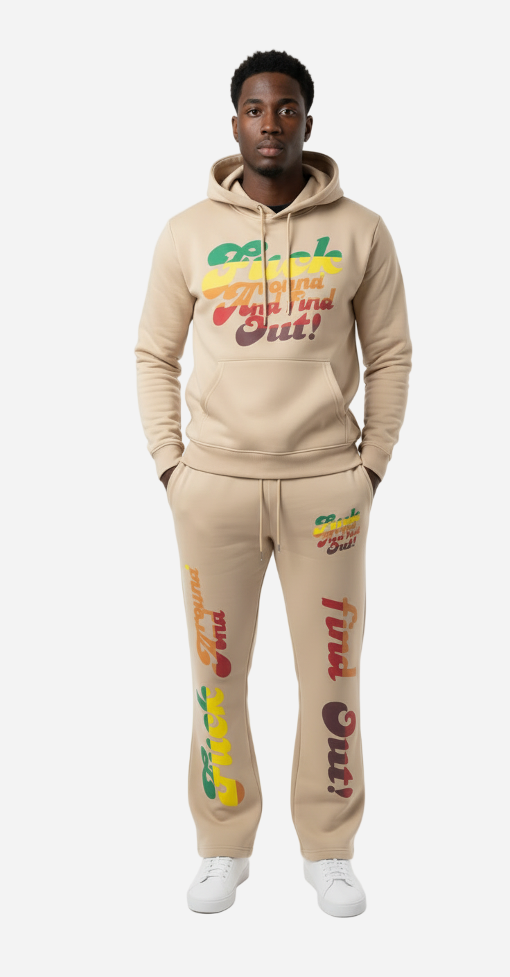Man wearing a beige hoodie and pants with colorful text and graphics on a white background
