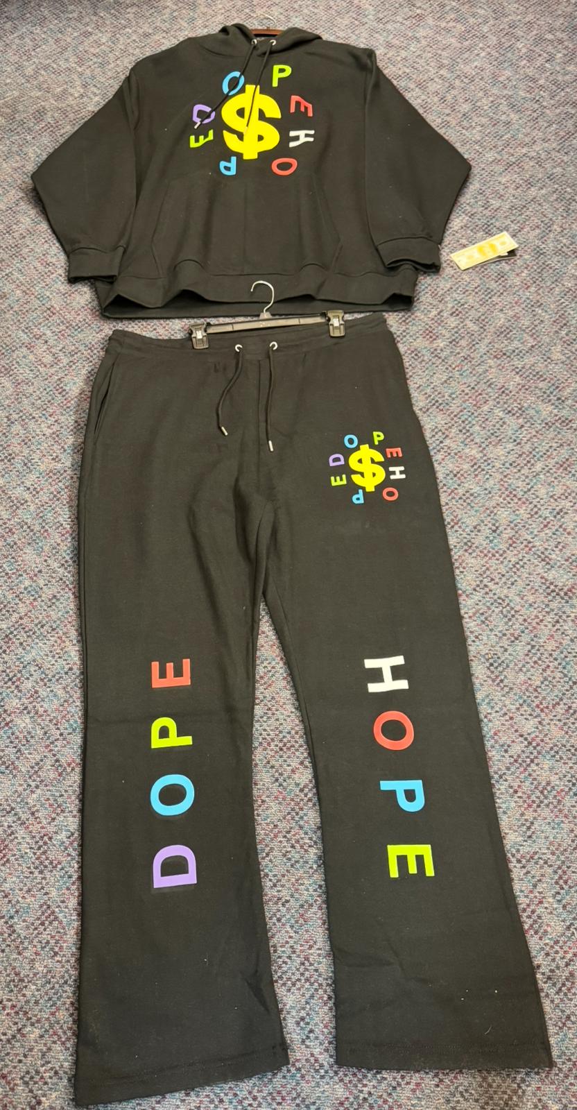 Dark gray hoodie and pants set with colorful text and dollar sign design on a textured surface.