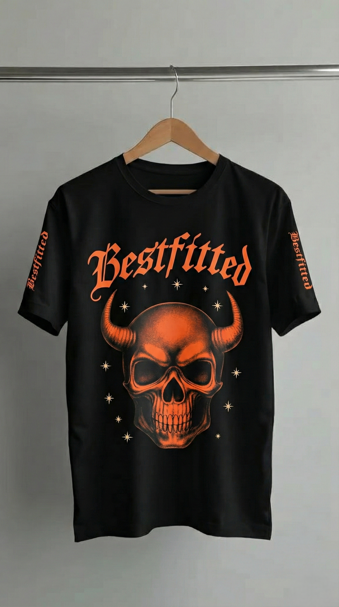 Black t-shirt with a skull design and 'Bestfitted' text on a hanger against a gray background