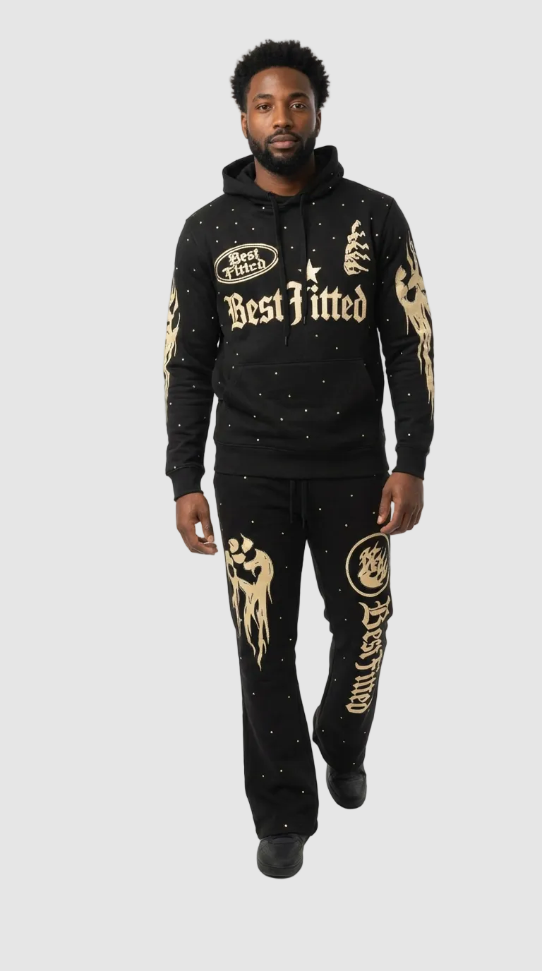 Man wearing a black hoodie and pants with gold text and designs on a white background