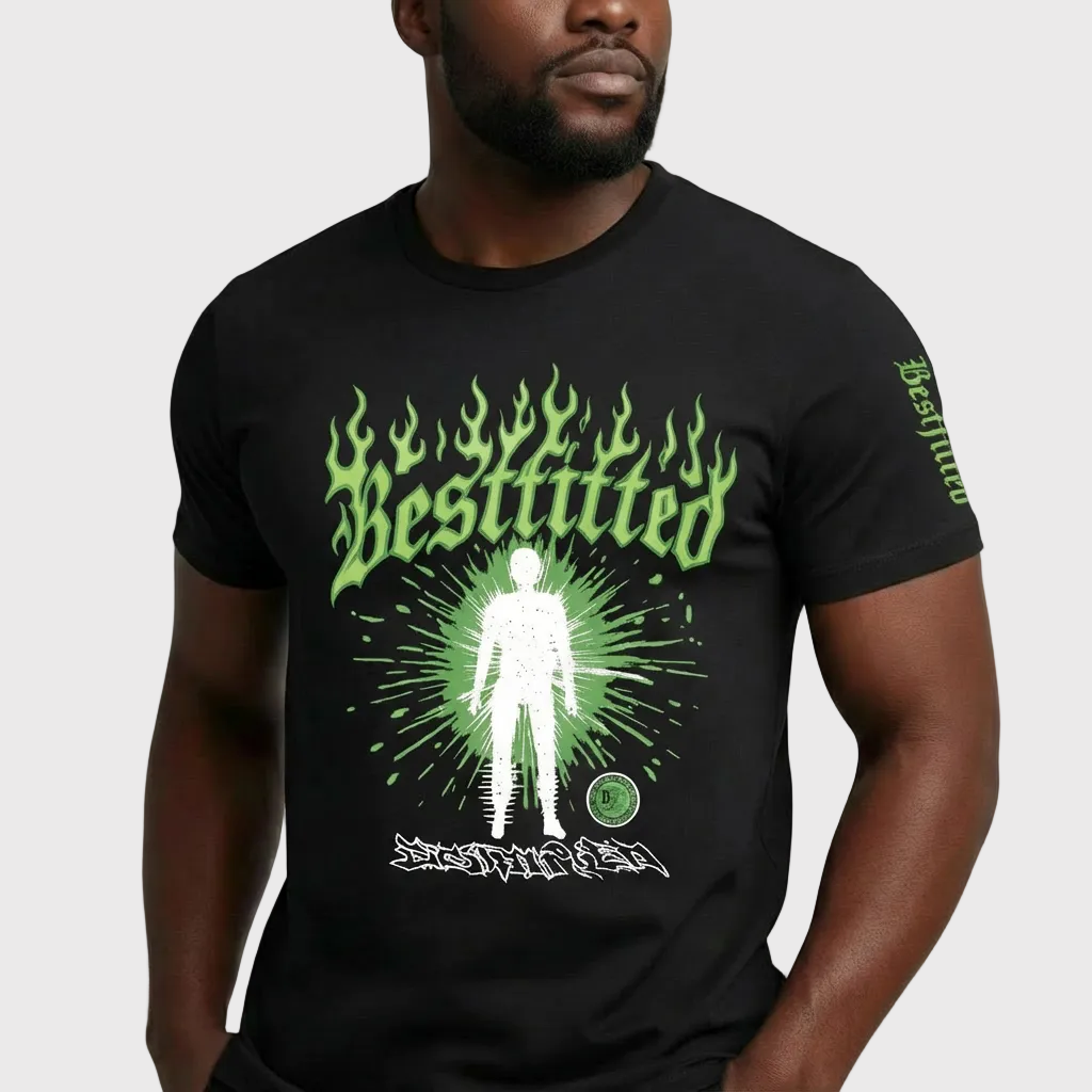 Person wearing a black t-shirt with green and white graphic design on a plain background