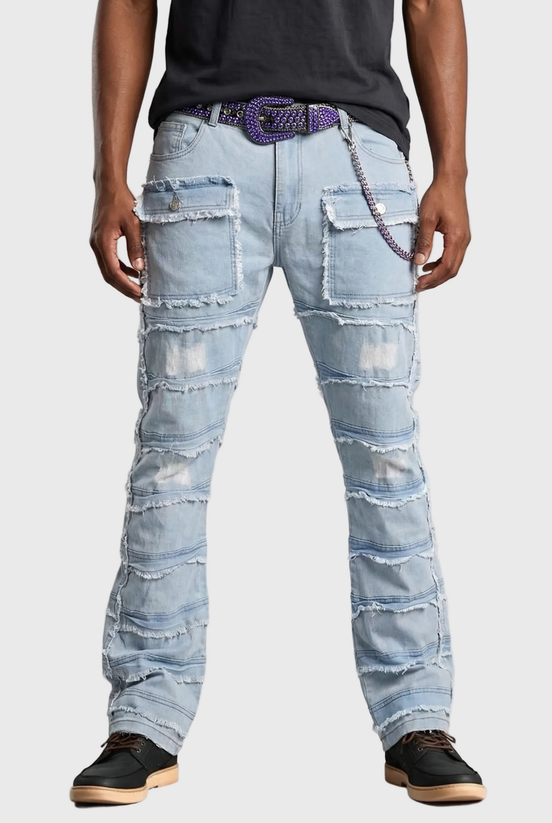 Person wearing light blue distressed jeans on a gray background