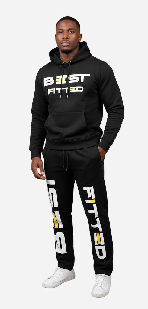 Person wearing a black hoodie and pants with 'BEST FITTED' branding on a gray background